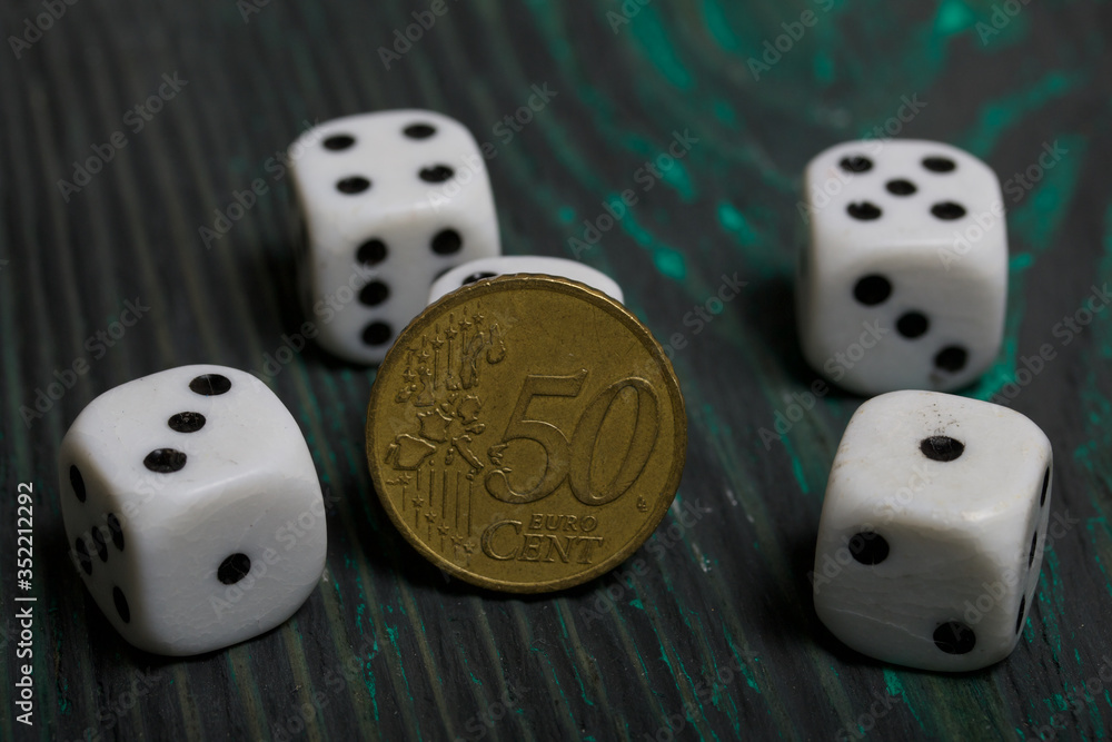 Dice in white with black dots and a coin. On brushed pine boards. Dice in white with black dots and a coin. On brushed pine boards.