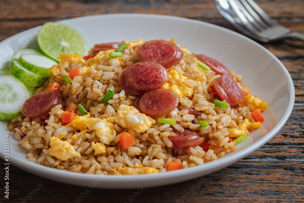 Fried rice with chinese sausage on plate . Fried rice with chinese sausage on plate .