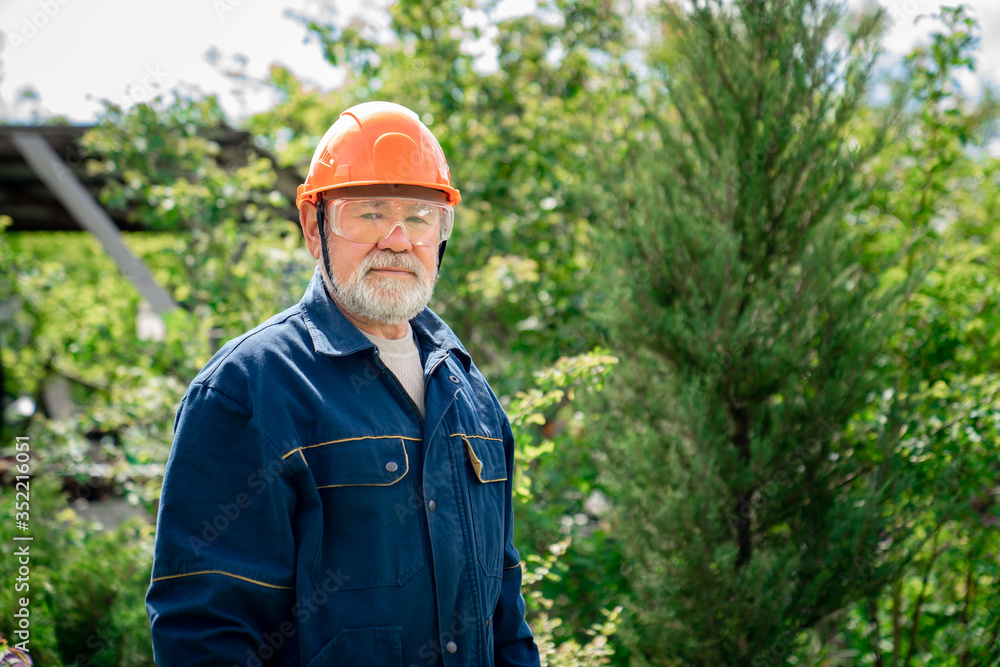 elderly man with a beard in protective helmet and goggles. elderly man with a beard in protective helmet and goggles.