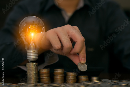 business person holding a light bulb