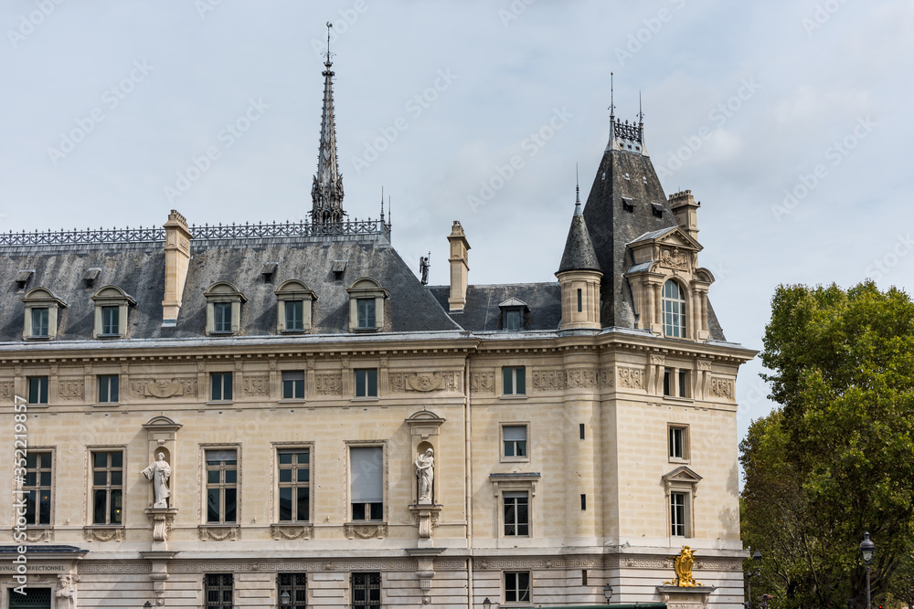 Historic La Conciergerie Buildings and tower of Notre Dame Cathedral in the Ile de la Cite in central Paris, France.