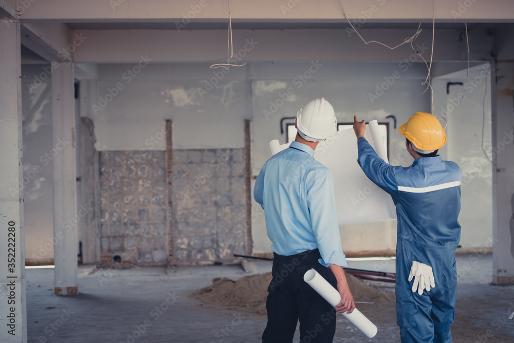 Engineer team with hard hat and blueprint talking together at the building construction site. Engineer team with hard hat and blueprint talking together at the building construction site.