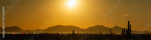 Long exposure panorama of the full moon rising on the desert and city of Phoenix, Arizona.