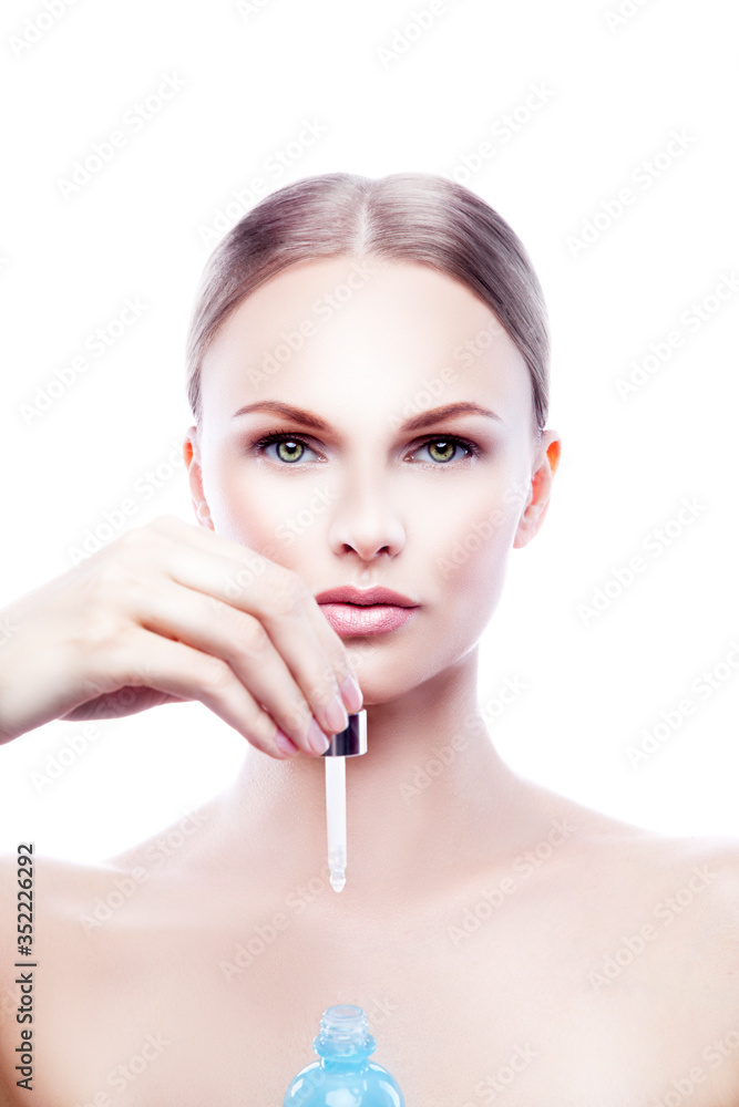 Beauty model woman portrait with droplet of cosmetics cream hyaluronic bottle in hand Beauty model woman portrait with droplet of cosmetics cream hyaluronic bottle in hand