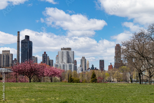 An Empty Grass Field at Rainey Park during Spring in Astoria Queens New York with the Roosevelt Island and Upper East Side Skyline photo