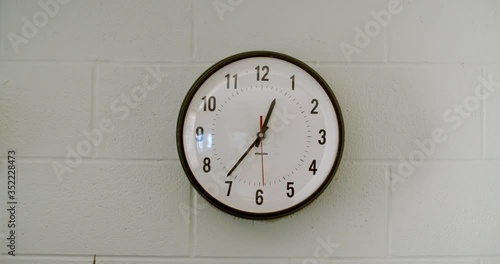 Close up of analog clock on wall in school cafeteria