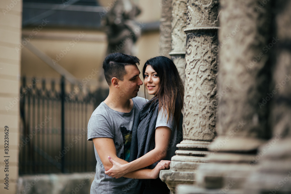 couple posing on the streets of a European city in summer weather.