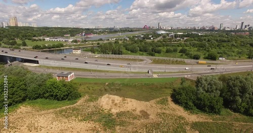 4K aerial summer late afternoon high quality video footage of new road highway, Grebnoi rowing water sports channel, cloudy sky in suburb Krilatskoye, Moscow River watercourse in Moscow, Russia photo