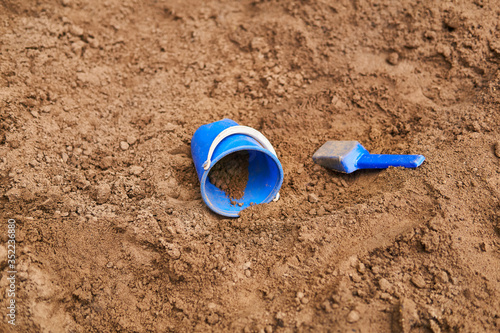 children's bucket and scoop are forgotten in the sandbox