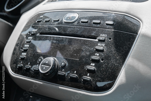 Dusty, uncleaned car radio closeup