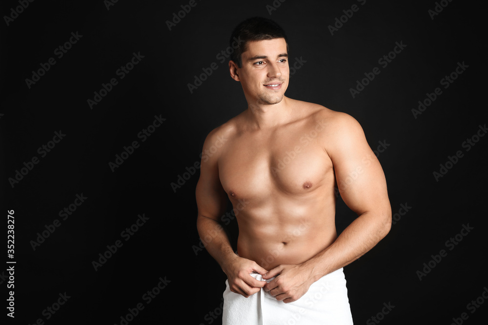 Fototapeta premium Man with sexy body on black background. Space for text