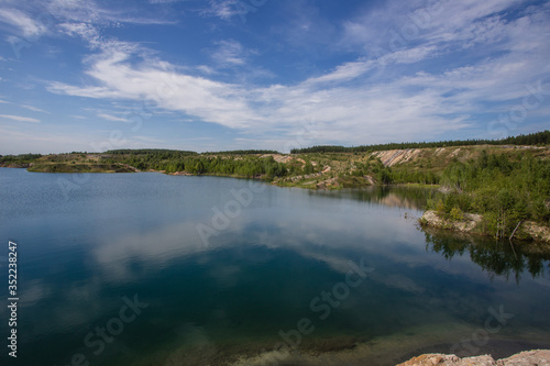 Flooded kaolin clay open pit quarry with blue water lake © Mishainik