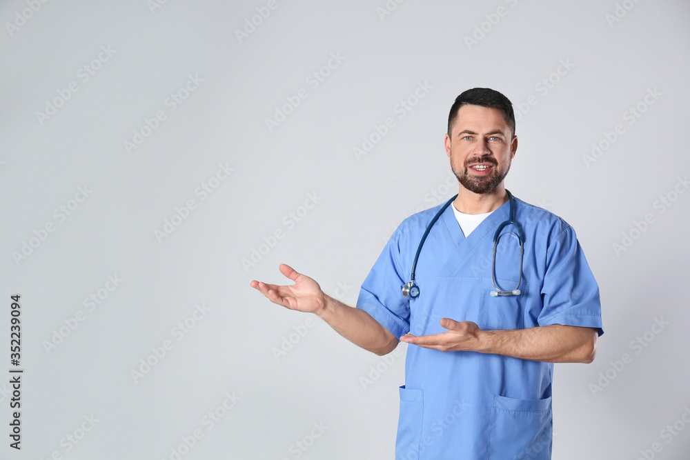 Portrait of mature doctor against light background Portrait of mature doctor against light background