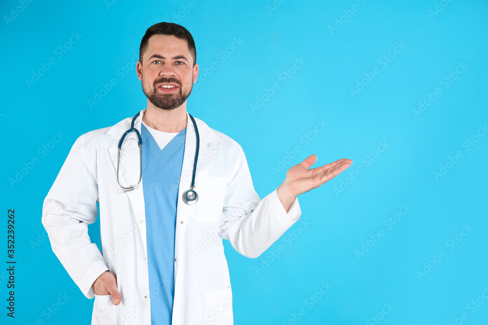 Mature doctor with stethoscope on blue background, space for text Mature doctor with stethoscope on blue background, space for text