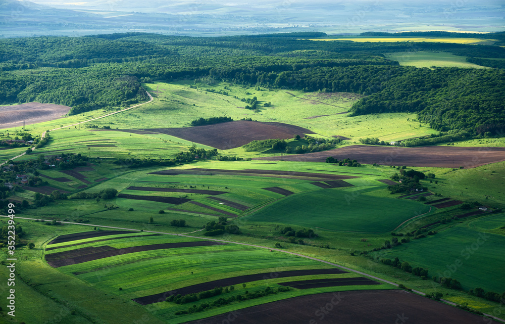 View on the field from the air. Agricultural landscape at the summer time. Composition from the drone. Agriculture - image View on the field from the air. Agricultural landscape at the summer time. Composition from the drone. Agriculture - image