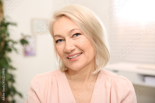 Portrait of beautiful mature woman at home