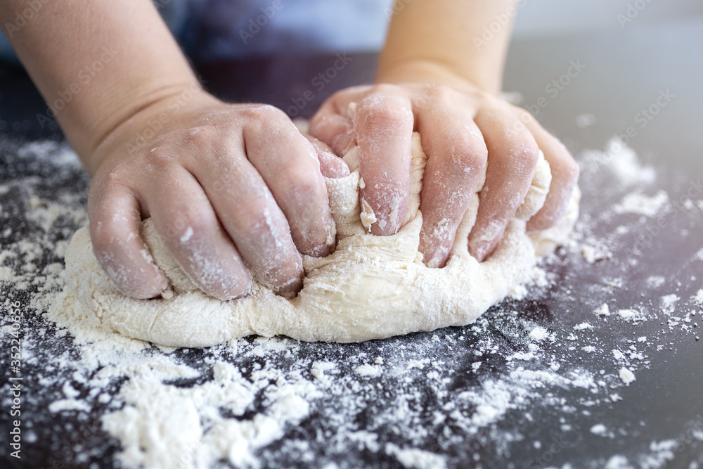 Close up of hands kneading dough for bread, pasta or pizza Close up of hands kneading dough for bread, pasta or pizza