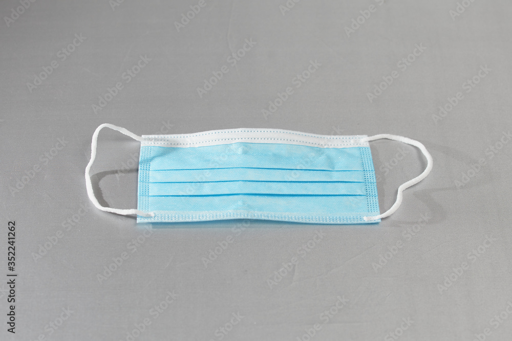 Protective medical masks on a gray background Protective medical masks on a gray background