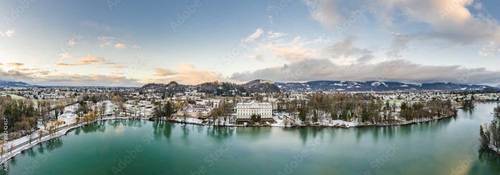 Aerial drone shot view of Leopoldskroner lake southwest of outskirts of Salzburg during winter