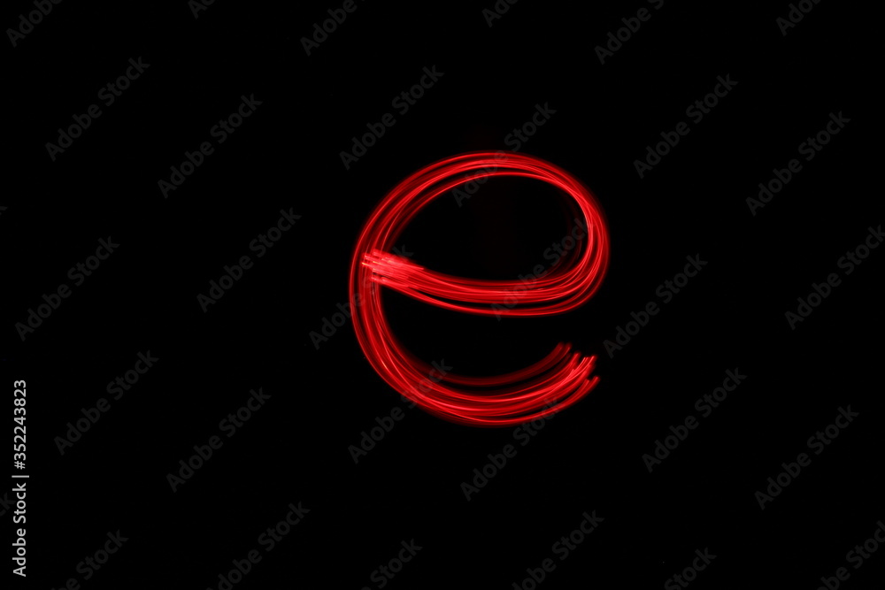 Long exposure photograph of the letter e in neon red colour fairy lights against a black background. Light painting photography. Part of an alphabet series. Long exposure photograph of the letter e in neon red colour fairy lights against a black background. Light painting photography. Part of an alphabet series.