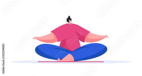 Cheerful man meditating in lotus pose at home