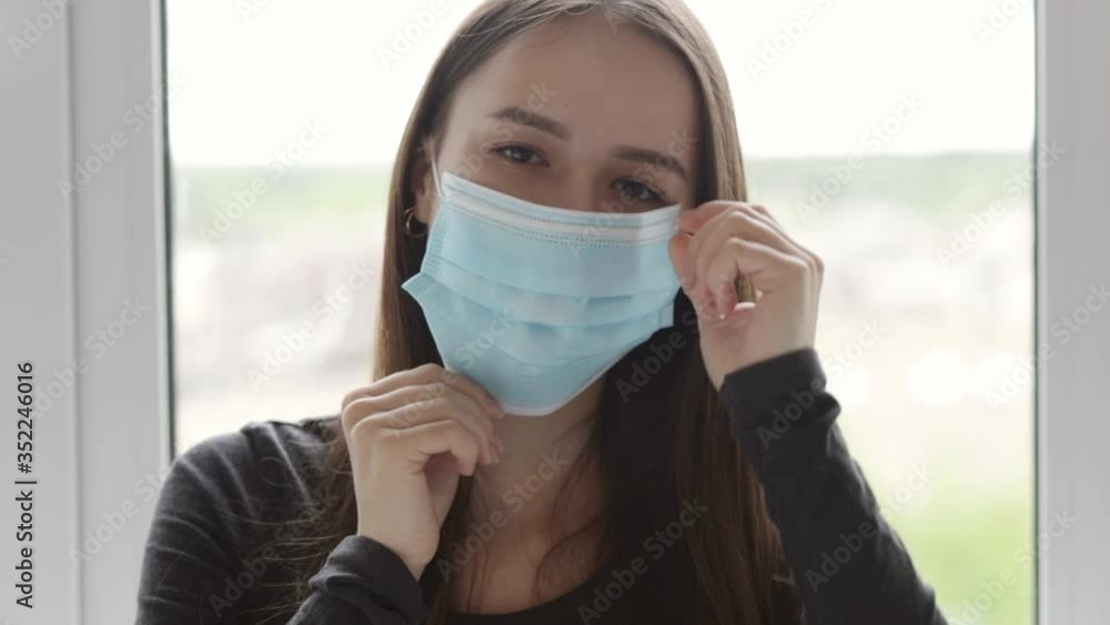 The screen is antiviral, the mask is antibacterial medical, gloves. Attractive girl puts on her face and hands protection from the virus. The screen is antiviral, the mask is antibacterial medical, gloves. Attractive girl puts on her face and hands protection from the virus.