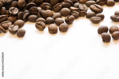 Lots of roasted coffee beans on a white background