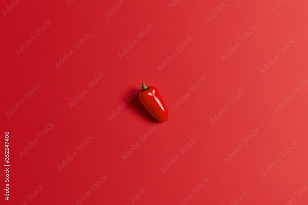 Sweet juicy red bell pepper isolated over bright background. Paprika for preparing delicious salad. Healthy food and fresh vegetables. Closeup and top view. Single vegetable. Autumn harvest. Sweet juicy red bell pepper isolated over bright background. Paprika for preparing delicious salad. Healthy food and fresh vegetables. Closeup and top view. Single vegetable. Autumn harvest.