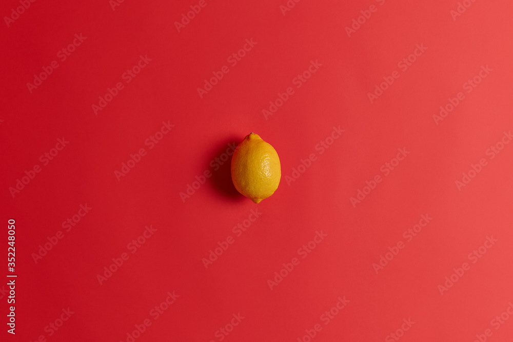 Fresh yellow sour lemon rich in vitamin C, folate, fiber and potassium to strengthen your immunity, cure cold or flu. Succulent juicy tropical citrus fruit isolated isolated on red background. Fresh yellow sour lemon rich in vitamin C, folate, fiber and potassium to strengthen your immunity, cure cold or flu. Succulent juicy tropical citrus fruit isolated isolated on red background.