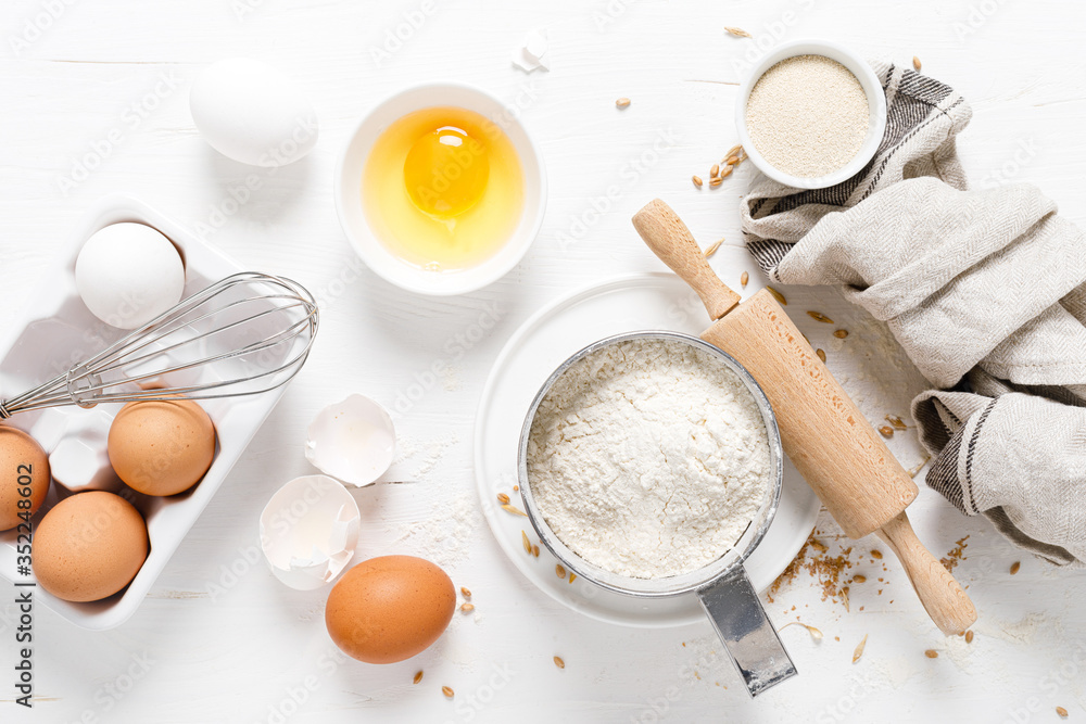Baking homemade bread on white kitchen worktop with ingredients for cooking, culinary background, copy space, overhead view Baking homemade bread on white kitchen worktop with ingredients for cooking, culinary background, copy space, overhead view