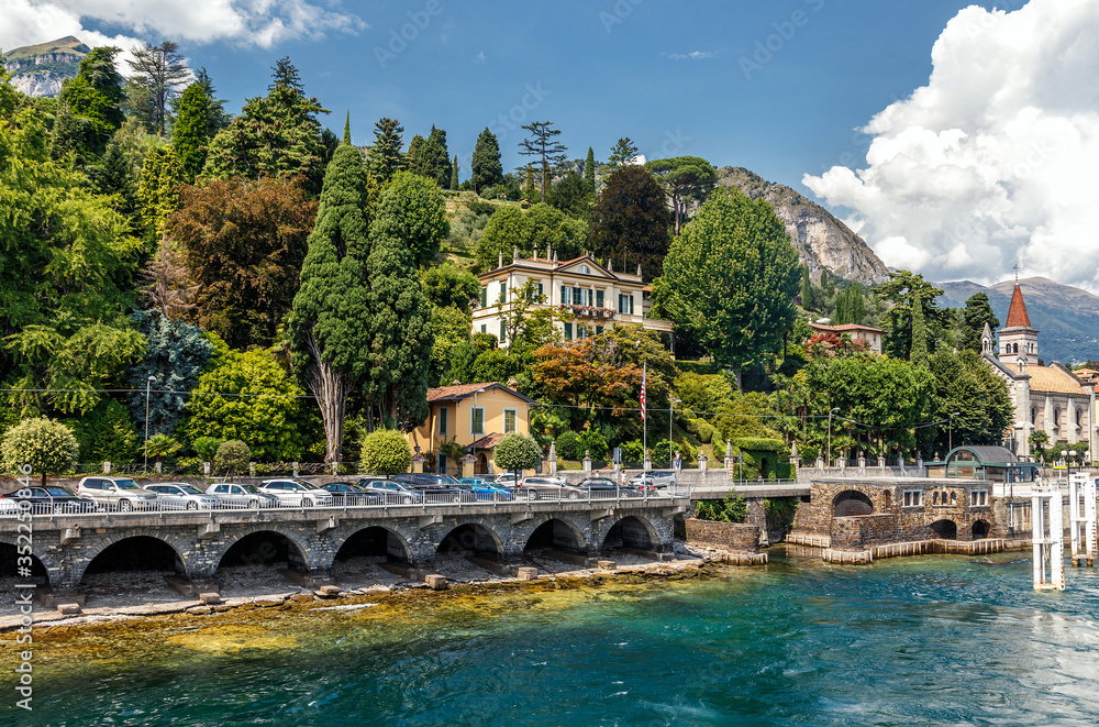 Beautiful coastline with old town by the Maggiore lake. Italy. Wonderful view on popular historical tourist resort town Cannero Riviera on Lago Maggiore lake, Alps mountains, Italy
