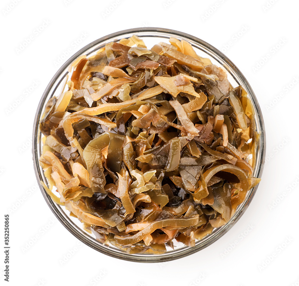 Seaweed in a plate close-up on a white, isolated. The view from top Seaweed in a plate close-up on a white, isolated. The view from top