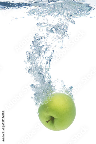 Green apple in water