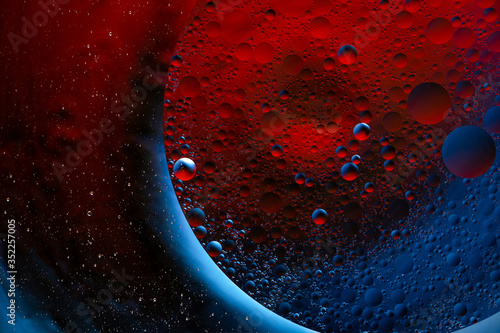 Abstract space and cosmos background. Creative abstract geometric red and blue background with water bubbles. Molecules or cosmic spheres  planets. Macro shot  selective focus