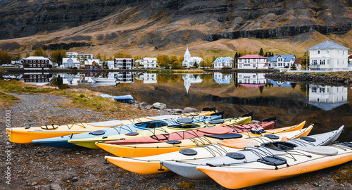 Amazing nature of Iceland. Panoramic view of Seydisfjordur with houses and surrounding landscape reflecting in Fjardara lake. impressively beautiful Icelandic landscape. Popular travel destination photo