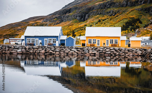 Amazing nature of Iceland. Panoramic view of Seydisfjordur with houses and surrounding landscape reflecting in Fjardara lake. impressively beautiful Icelandic landscape. Popular travel destination photo