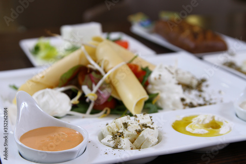 Breakfast with salad and several types of cheese and sauces