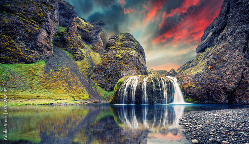 Canvas Print Fantastic Evening landscape with colorful skyover the waterfall during sunset