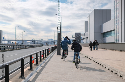 Photography Unidentified people riding bicycle together and go for a walk in clean city