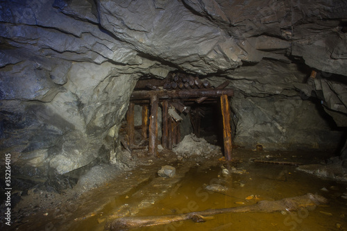Underground old mica mine tunnel with collapsed wooden orechute