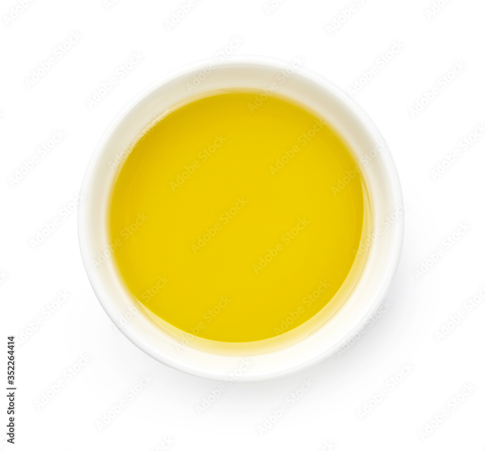 Bowl of olive or vegetable oil isolated on white. Top view of oil. Bowl of olive or vegetable oil isolated on white. Top view of oil.