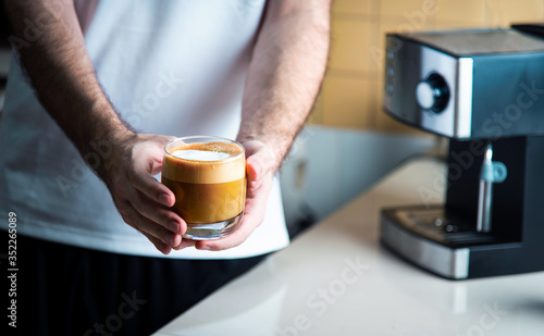 Man holding homemade cappuccino at home