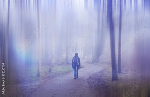 Woman walking in a surreal forest