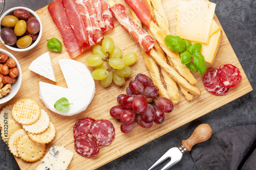 Cheese, meat, grapes and olives antipasto