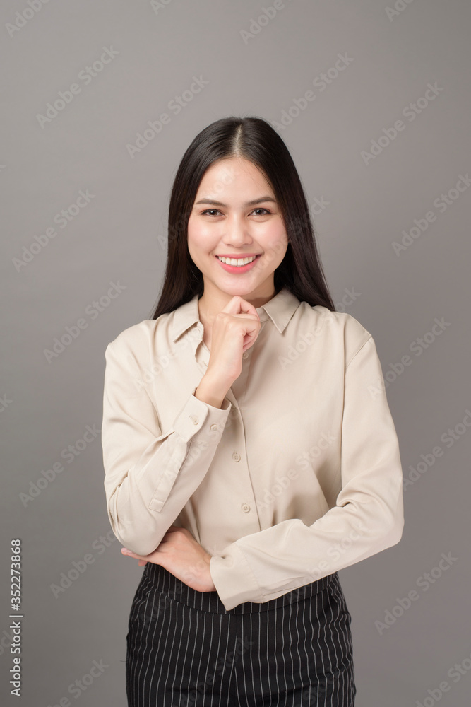 Portrait of beautiful business woman smiling on gray background Portrait of beautiful business woman smiling on gray background