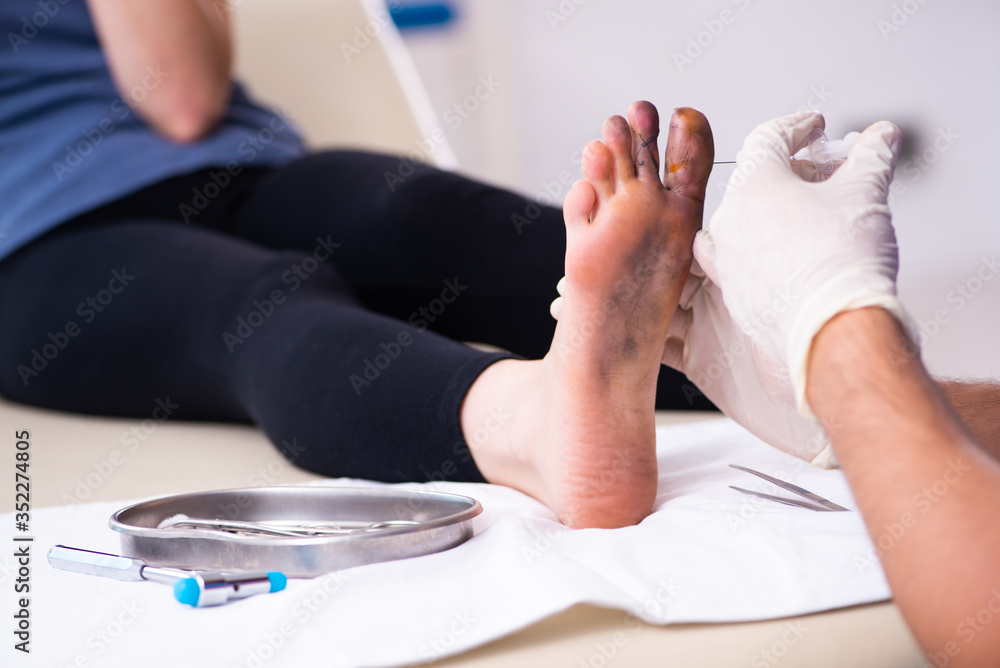 Fototapeta premium Finger injured woman visiting male doctor traumatologist