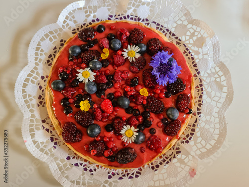 Dessert cake with Strawberry paste Raspberries blueberries and flowers