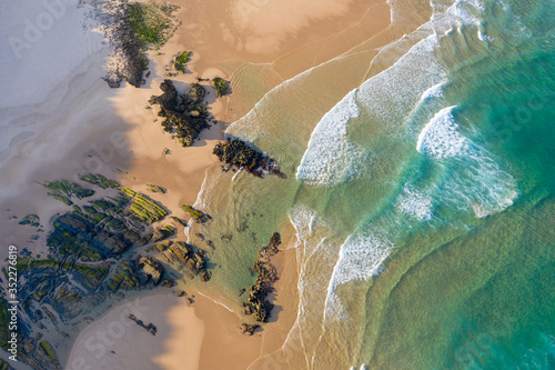 View from above of empty beach with rocks. Seaside vacation turism. Holidays by the beach