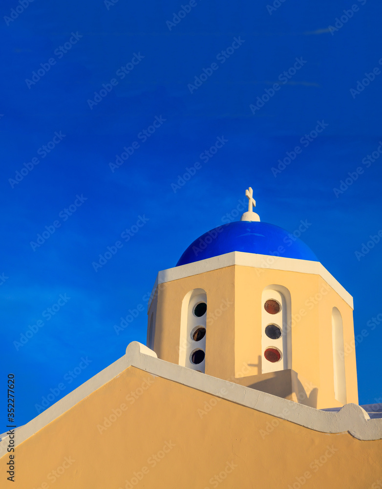 Church with blue dome against blue sky background. Santorini, Greece.
