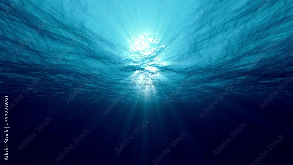 Slow motion of clean water looping light underwater video with beams of sunlight. 4K seamless loop